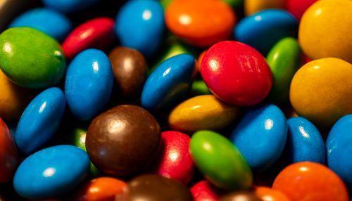 Free Vibrant macro of assorted candy-coated chocolates showing lively colors and textures. Stock Photo