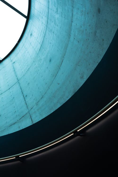 Free Low-angle view of minimalist concrete walls and glass ceiling in modern architecture. Stock Photo