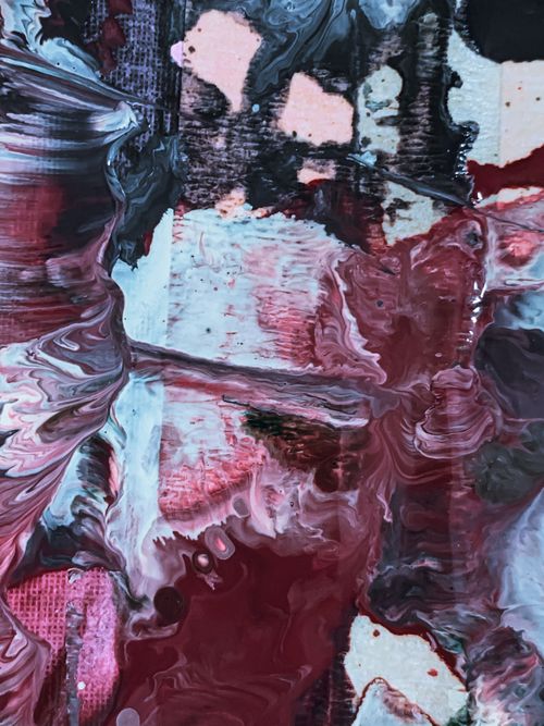 Free Abstract artwork with paintbrush and watercolor creating stains and swirls of acrylic red and dark paints on canvas of creative picture Stock Photo