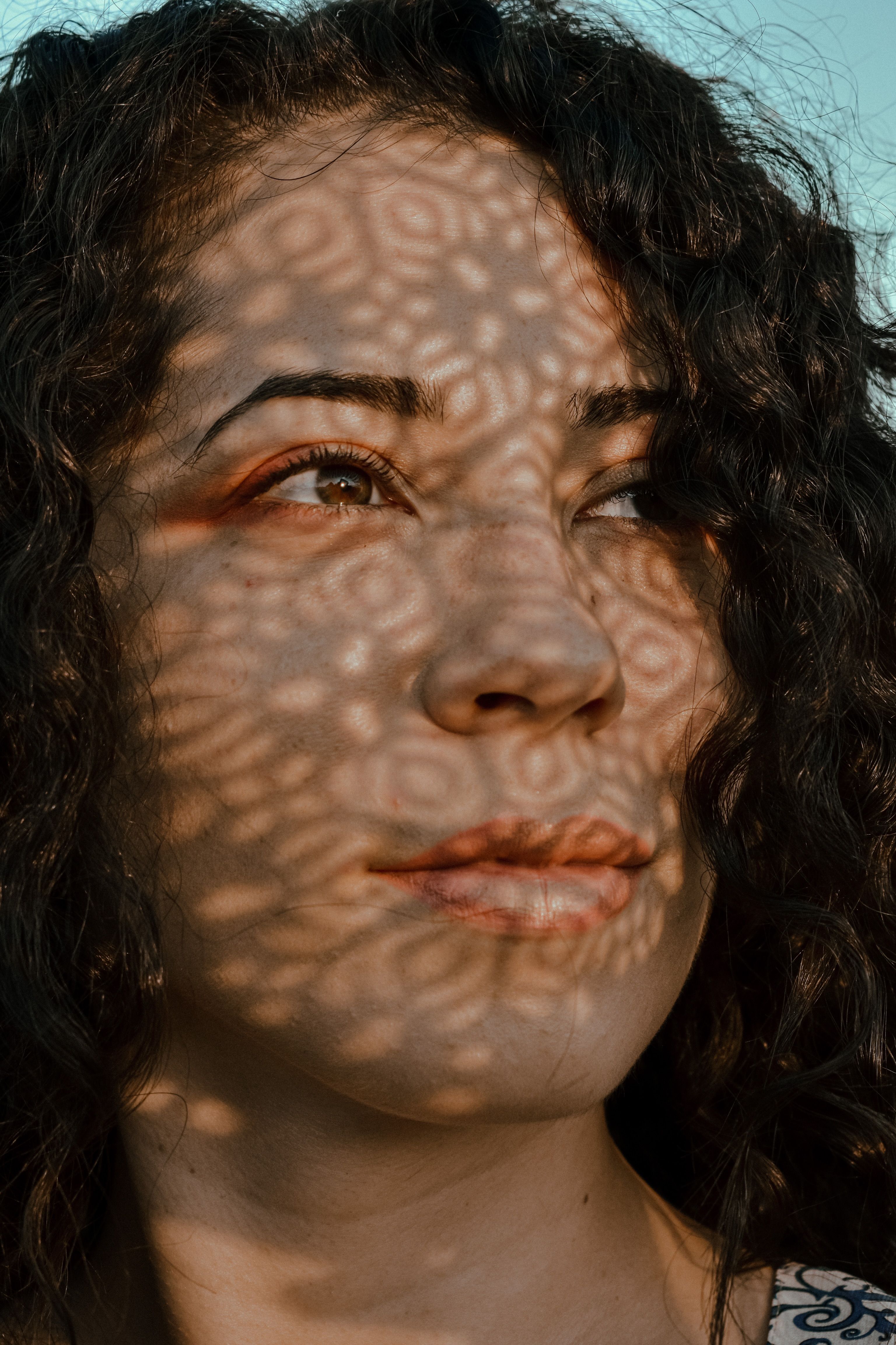 Crop positive woman with shadows on face standing outside · Free Stock ...
