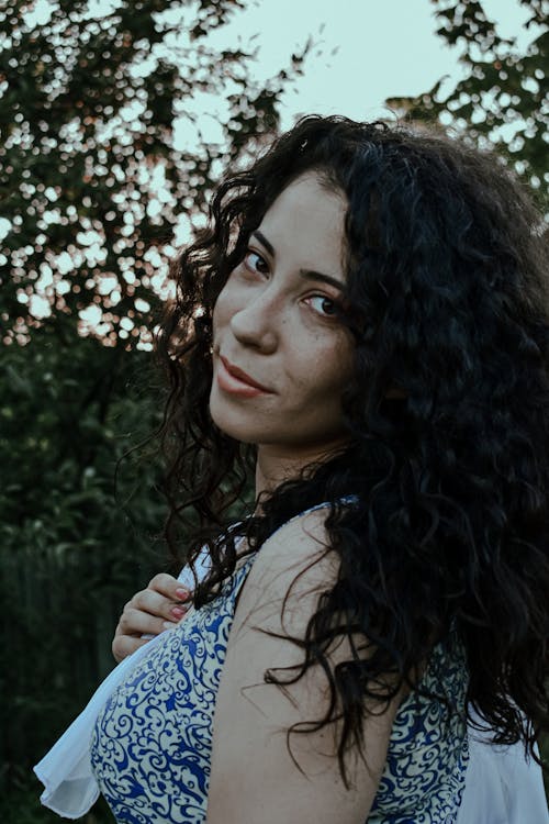 Dreamy woman enjoying summer day in park