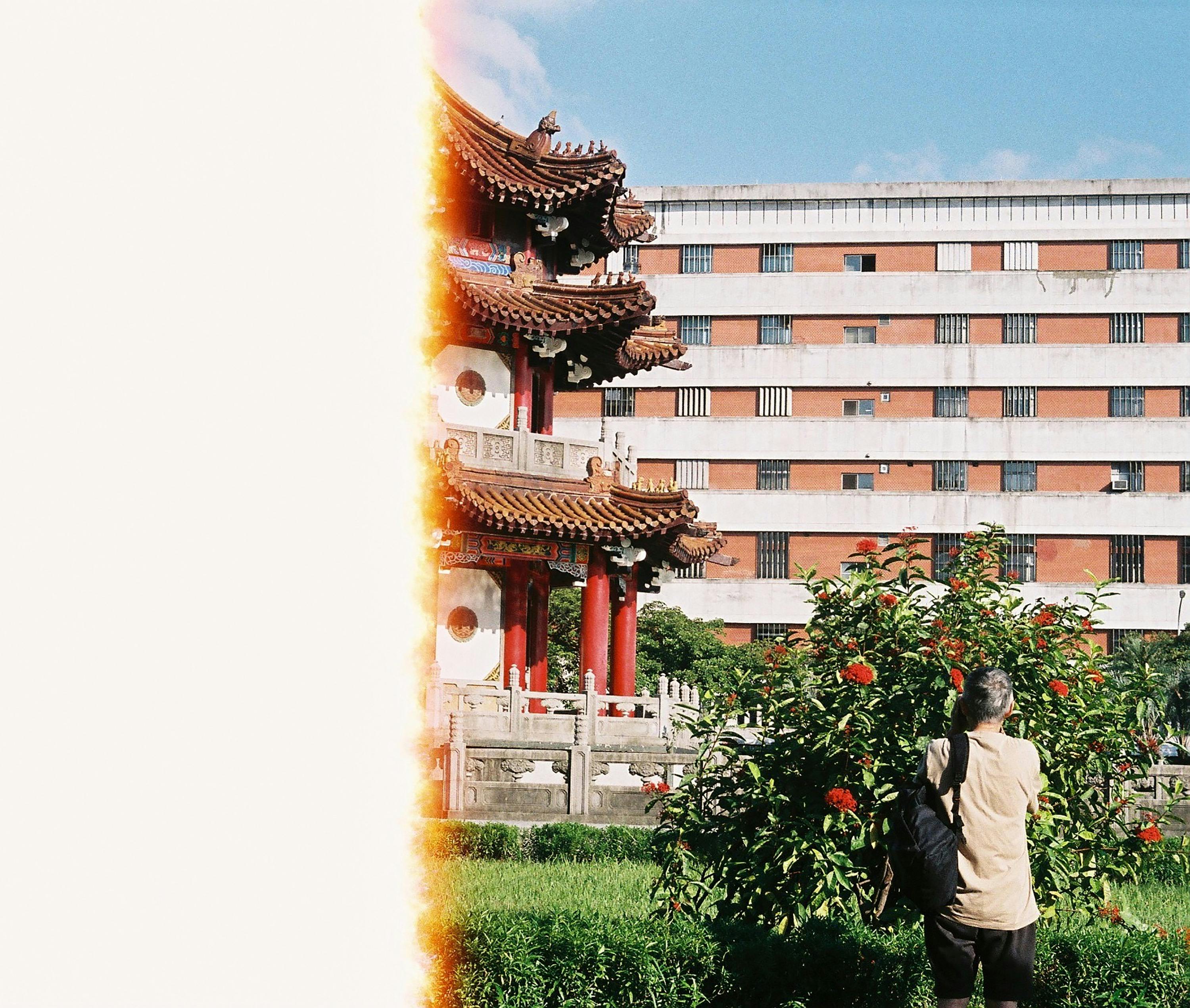 A tourist captures a Taiwanese pagoda with a film camera, set against a modern building backdrop.