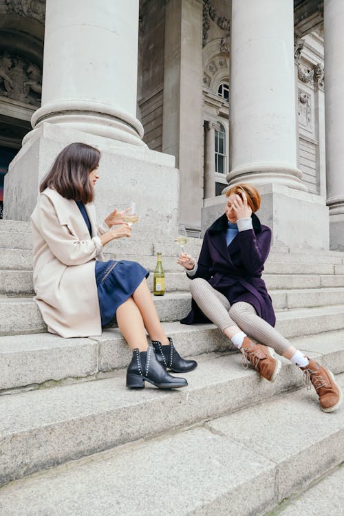 Women drinking Wine on Staircase