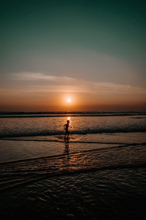 Silhouette of Person running on Seaside