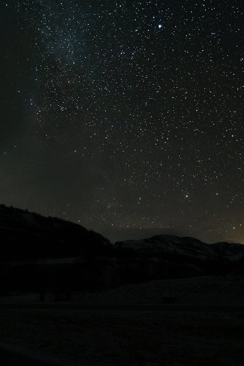 Silhouette of Mountain Under Starry Night