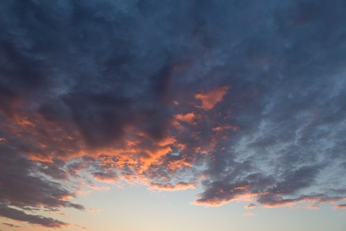 Free Beautiful sky with dramatic clouds at sunset illuminating warm colors. Stock Photo