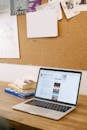 Macbook Pro on Brown Wooden Table