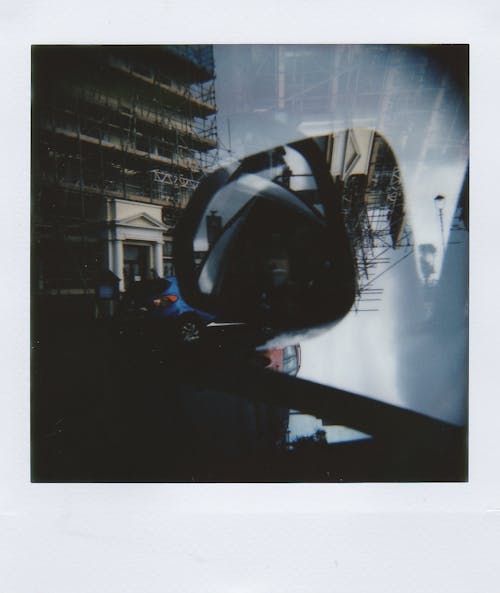 Free Polaroid Double Exposure Picture of a Side Mirror in a Car and City Street  Stock Photo