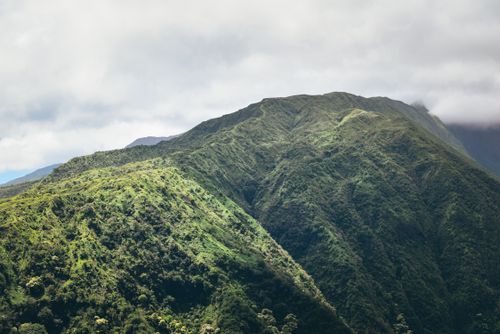 Free Spectacular landscape of mountain ridge covered with green plants under cloudy sky in daytime Stock Photo