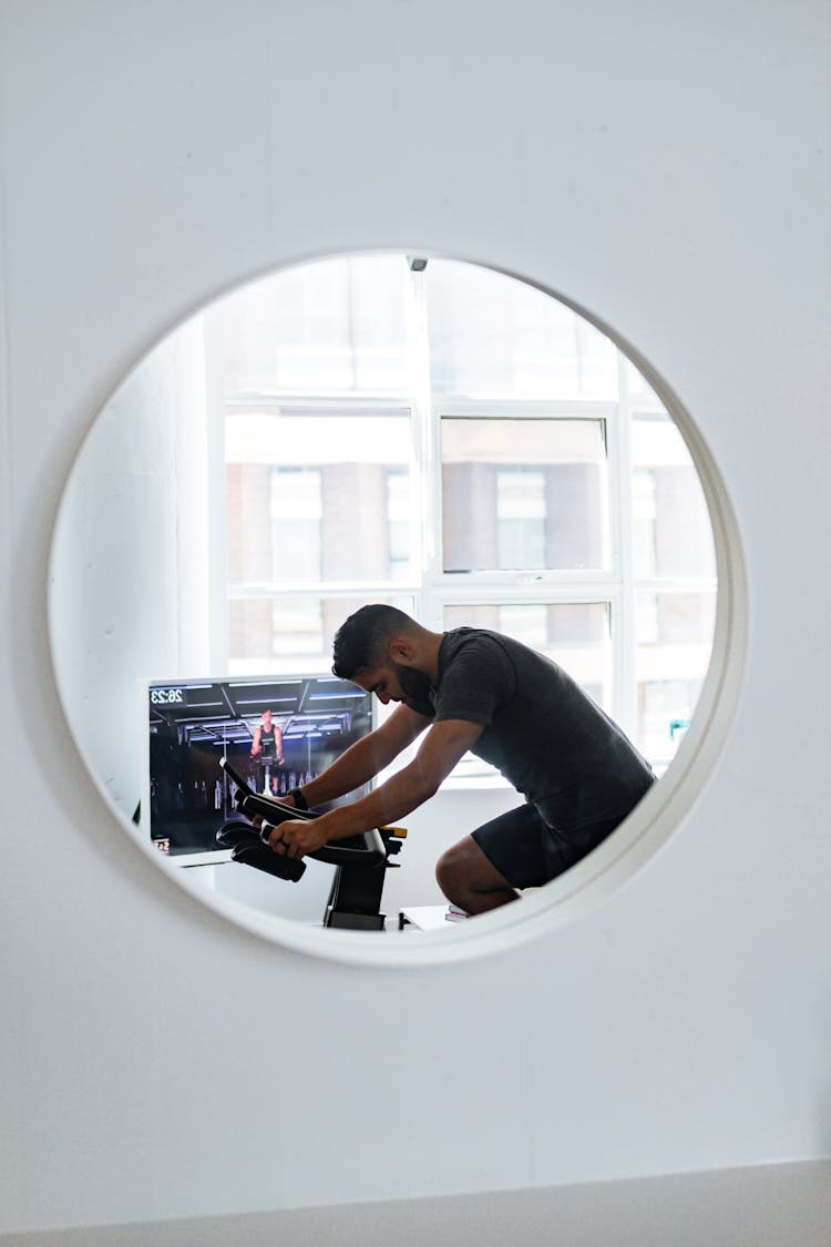 Mirror Reflection Of Focused Man Training At Home