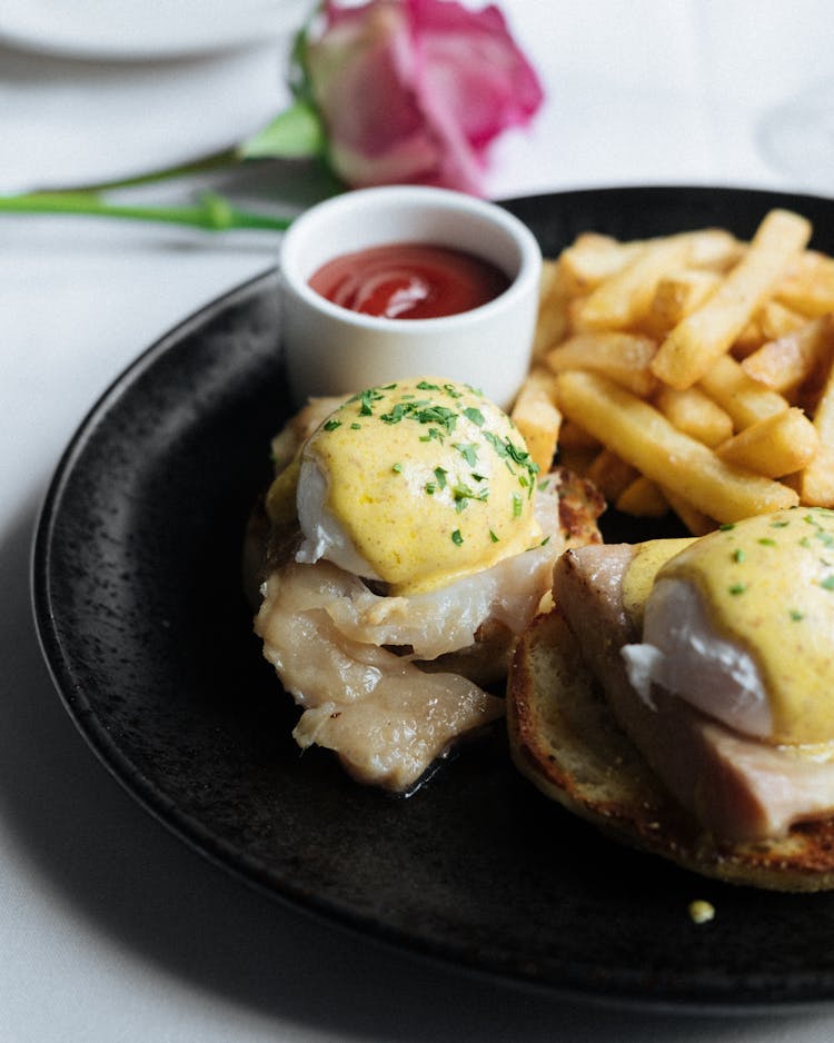 Eggs Benedict With French Fries And Salad Dressing