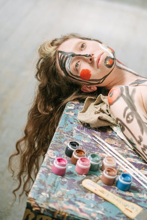 Woman with Painted Face Lying on Table
