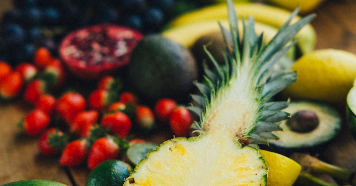 Photo by Viktoria Slowikowska A colorful display of fresh tropical fruits on a wooden table showcasing a healthy and vibrant lifestyle.