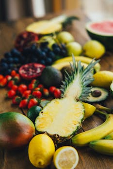 A colorful display of fresh tropical fruits on a wooden table showcasing a healthy and vibrant lifestyle.