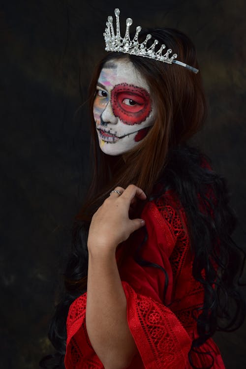 Woman with Face Paint Wearing a Red Dress