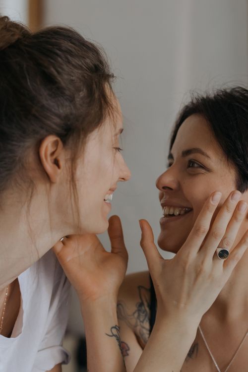Free Two women share an intimate and joyful moment, expressing love and connection. Stock Photo