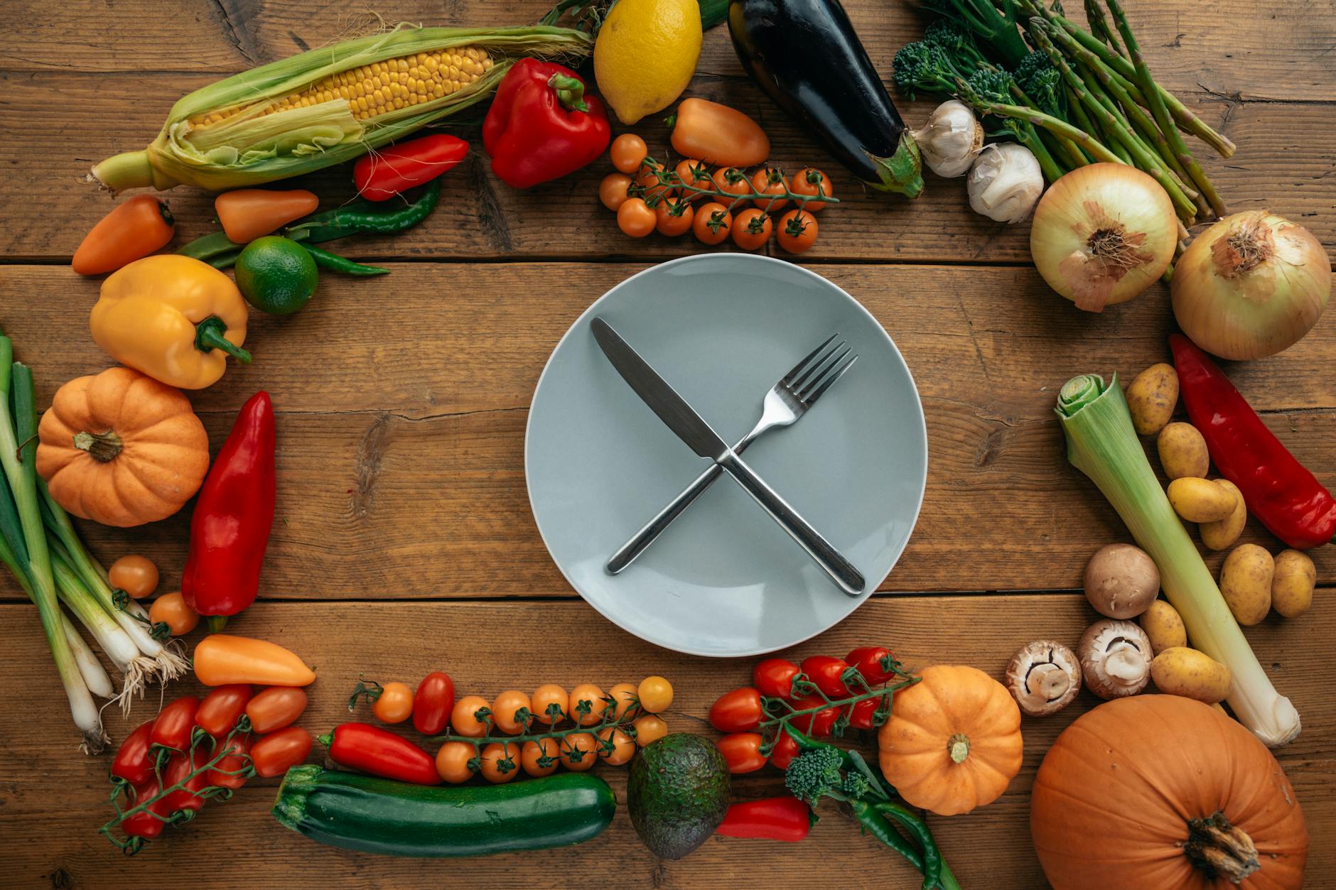 https://www.pexels.com/photo/knife-and-fork-on-a-ceramic-plate-surrounded-by-assorted-vegetables-5677621/