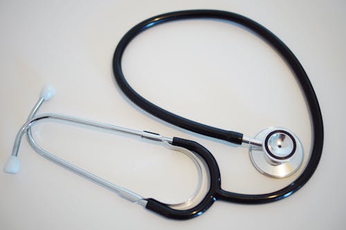 Free A Black and Silver Stethoscope on a White Surface Stock Photo