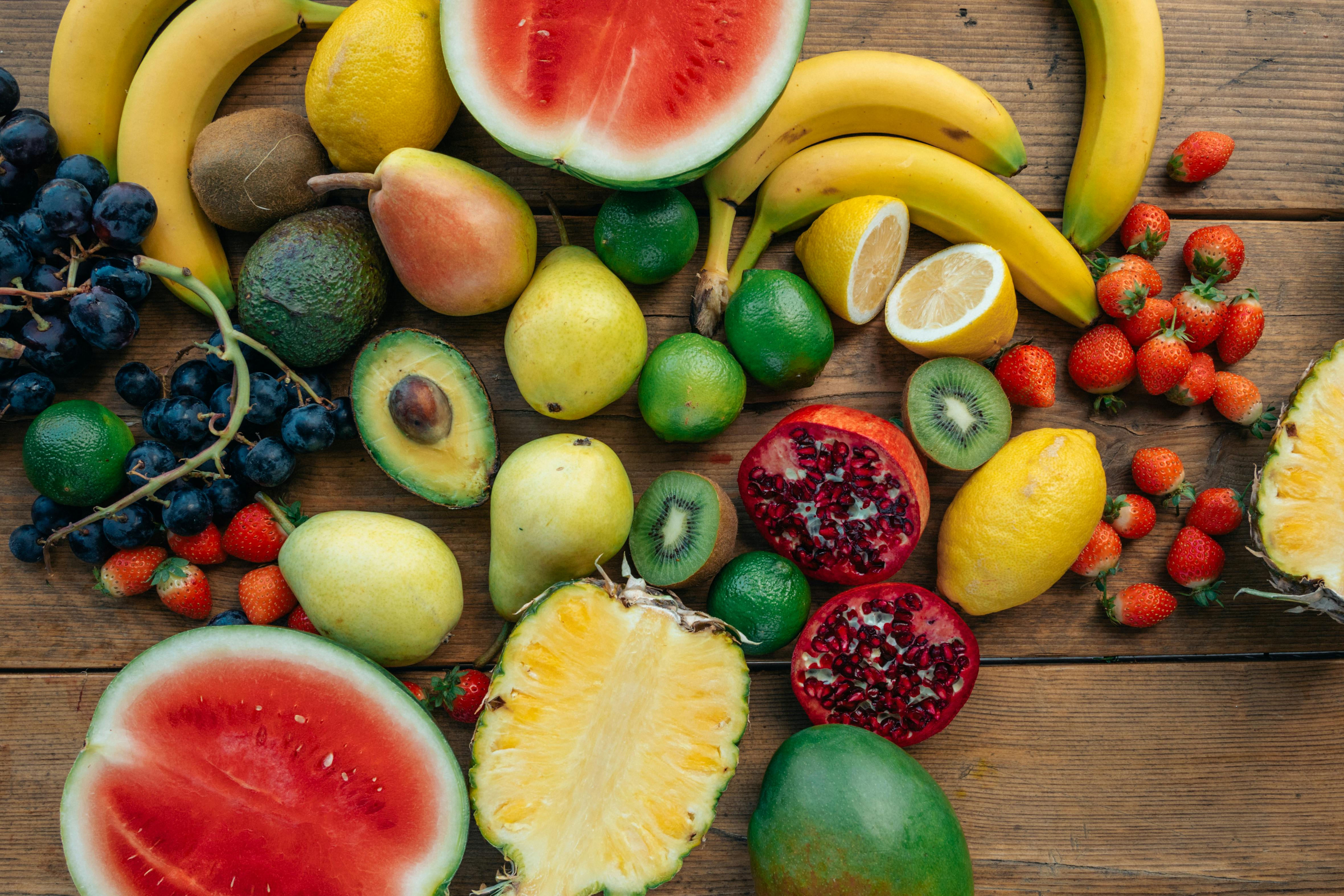 sliced red apple and green and yellow bananas