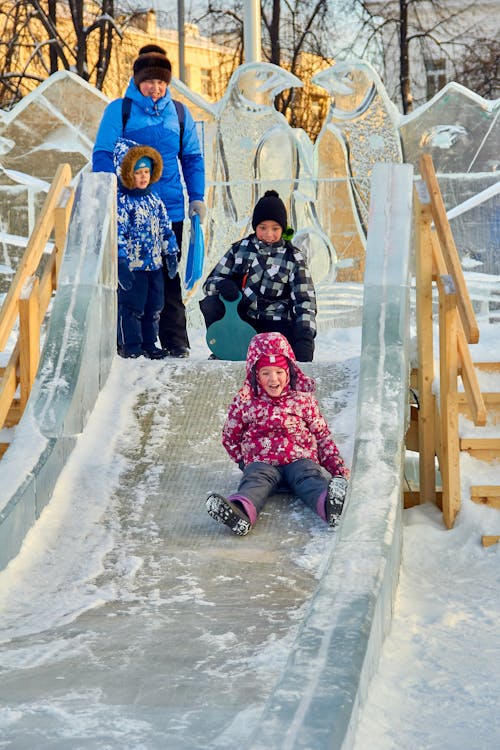 Free Children Sliding on Ice Stock Photo