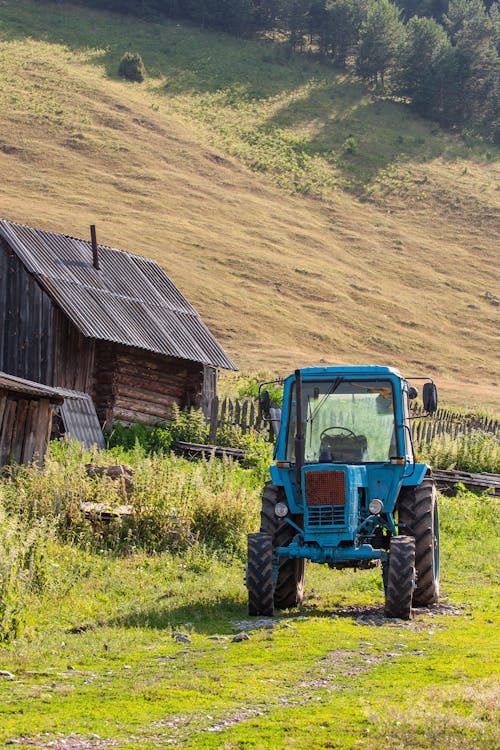 A Blue Tractor on a Grassy Field