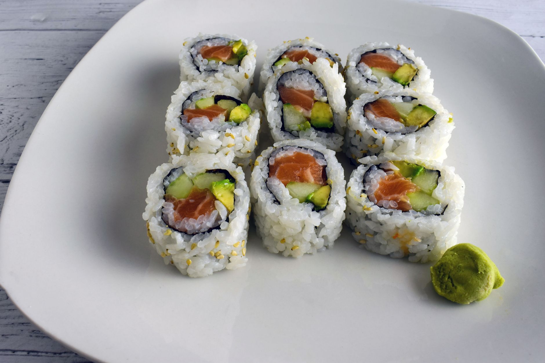 Freshly sliced Boston roll sushi on a wooden board