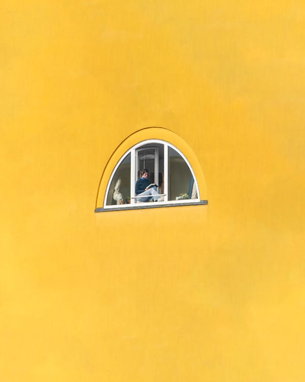 A Person Sitting on a Window