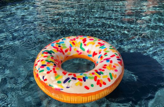 Pink Yellow and Blue Doughnut on Black and Gray Marble Table