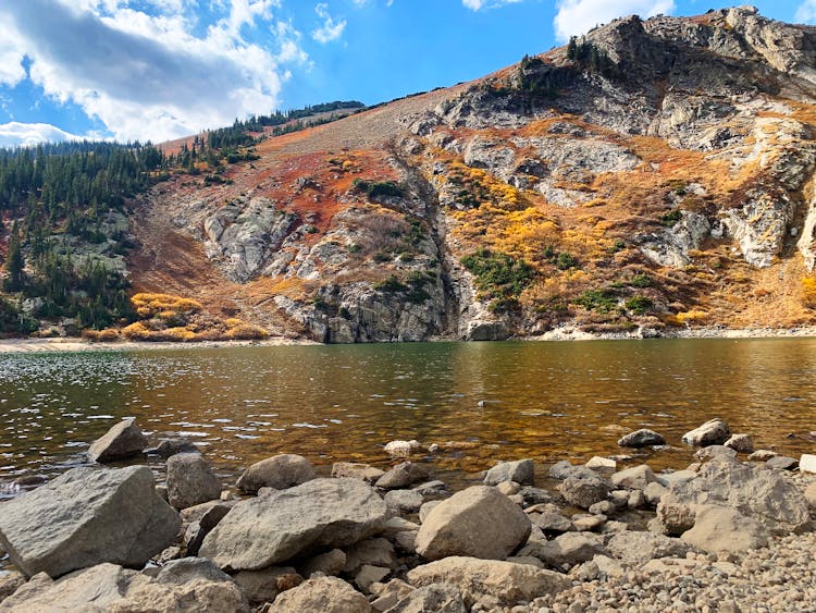 Rocks Beside A Lake And Mountain