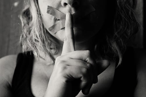 Woman Placing Her Finger Between Her Lips