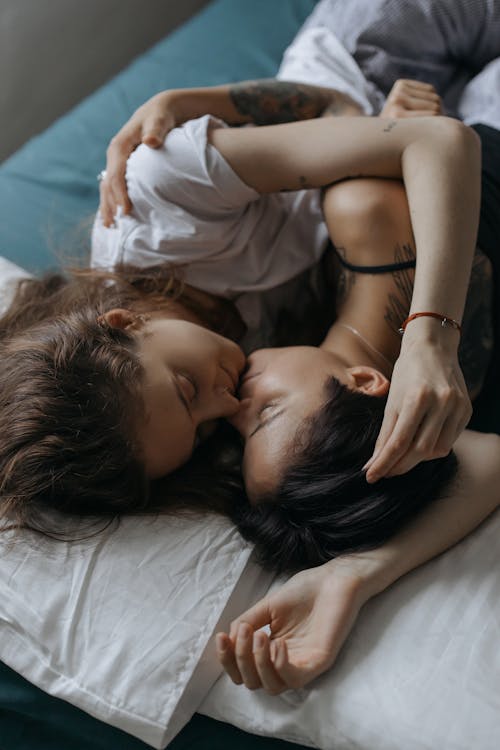 Free A Romantic Couple Hugging in the Bed Stock Photo