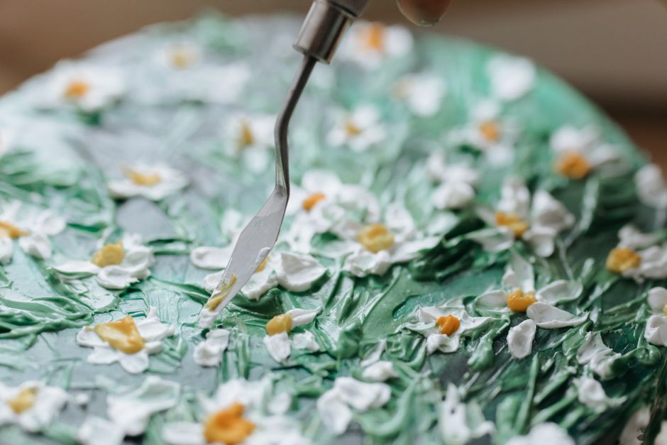 Close-up of a beautifully decorated floral cake with detailed icing work, perfect for occasions.