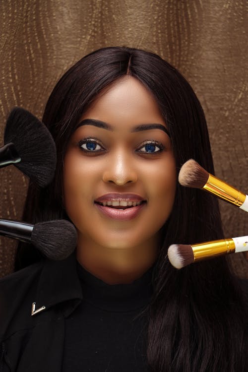 A Set of Makeup Brushes Near a Woman in Black Top