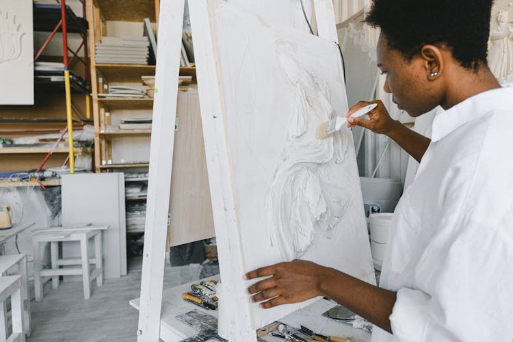 Woman Painting On A Canvas