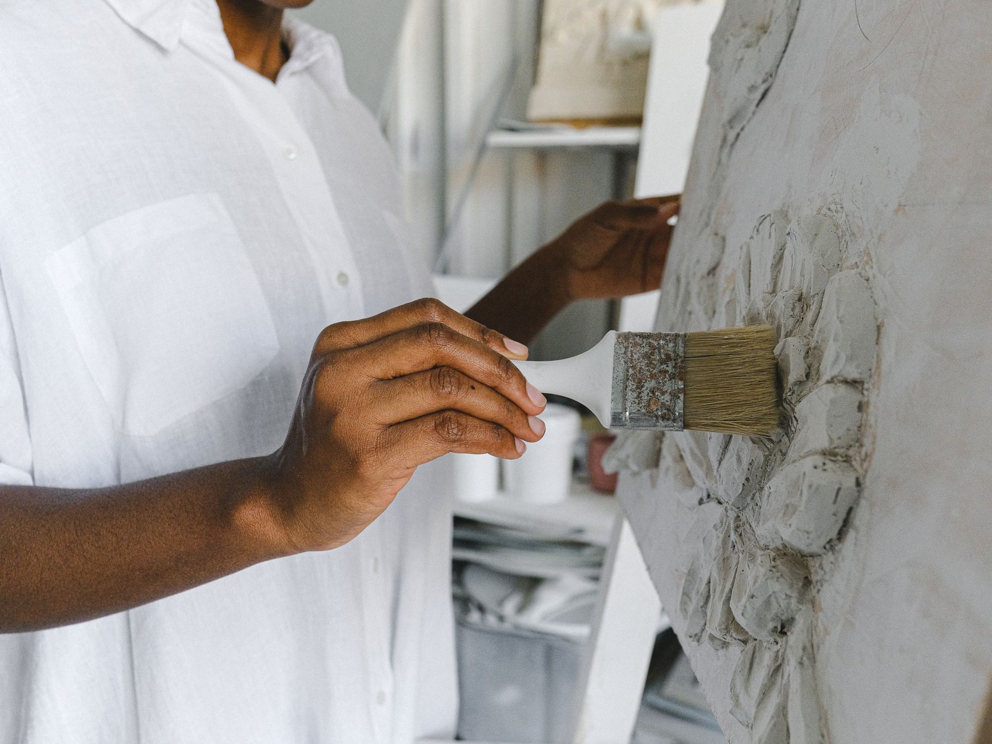 Painters & Decorators in Homerton, London — professional decorator painting a wall with a roller