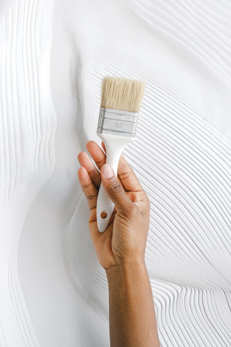 A Person Holding A Paintbrush
