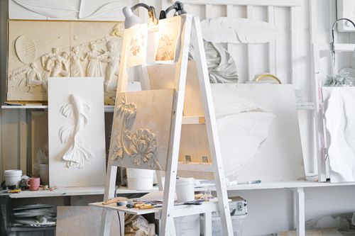 Free Art studio filled with diverse sculptures, tools, and materials, showcasing creativity and craftsmanship. Stock Photo