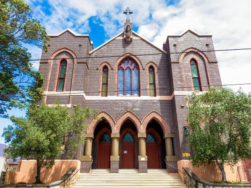 Free A low angle view of the Gothic facade of St Peter's Church in Surry Hills, Australia. Stock Photo