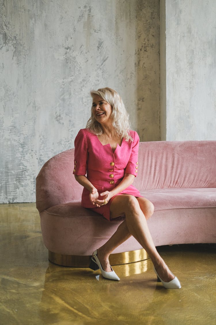 An Elderly Woman Sitting On A Couch