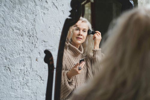 An Elderly Woman Putting on Makeup