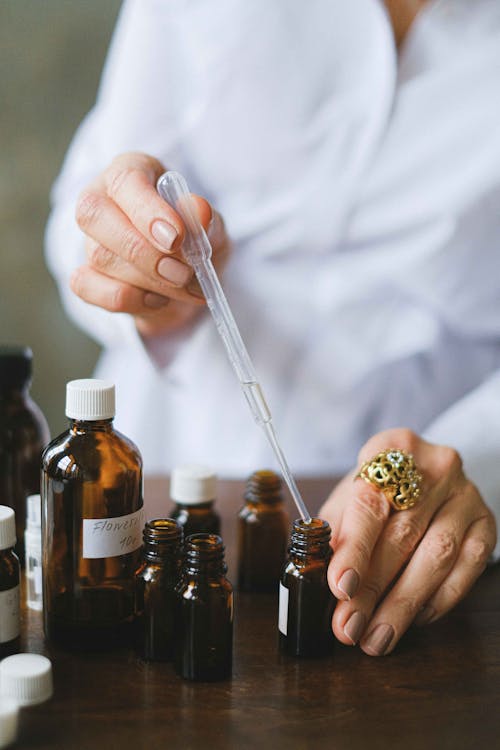 Selective Focus Photo of Dropper and Amber Bottles 