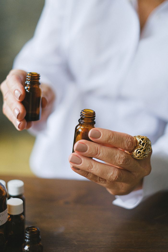 Hands holding amber glass bottles