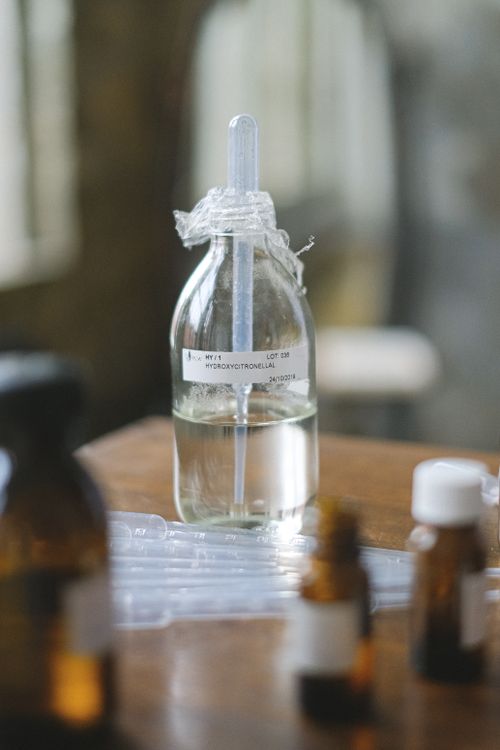 Free Glass bottles with liquid in a laboratory setting, featuring selective focus and blurred background. Stock Photo