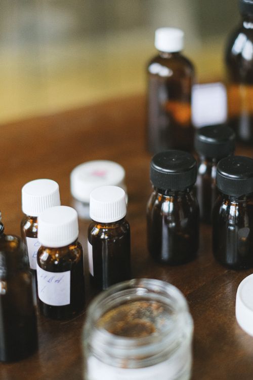 Free A variety of dark glass medicine bottles with white caps on a wooden table, suggesting a health theme. Stock Photo