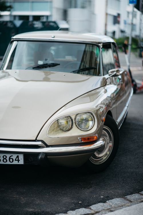 Free Classic beige Citroën car parked on a city street, capturing a vintage automotive style. Stock Photo