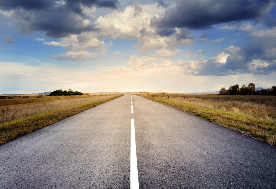 Asphalt Road Under Cloudy Sky