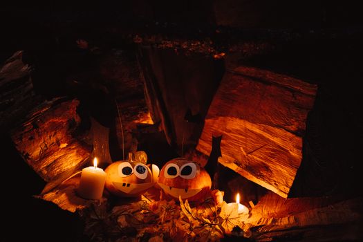 Charming jack-o'-lanterns with candles in a cozy autumn setting, perfect for Halloween atmosphere.