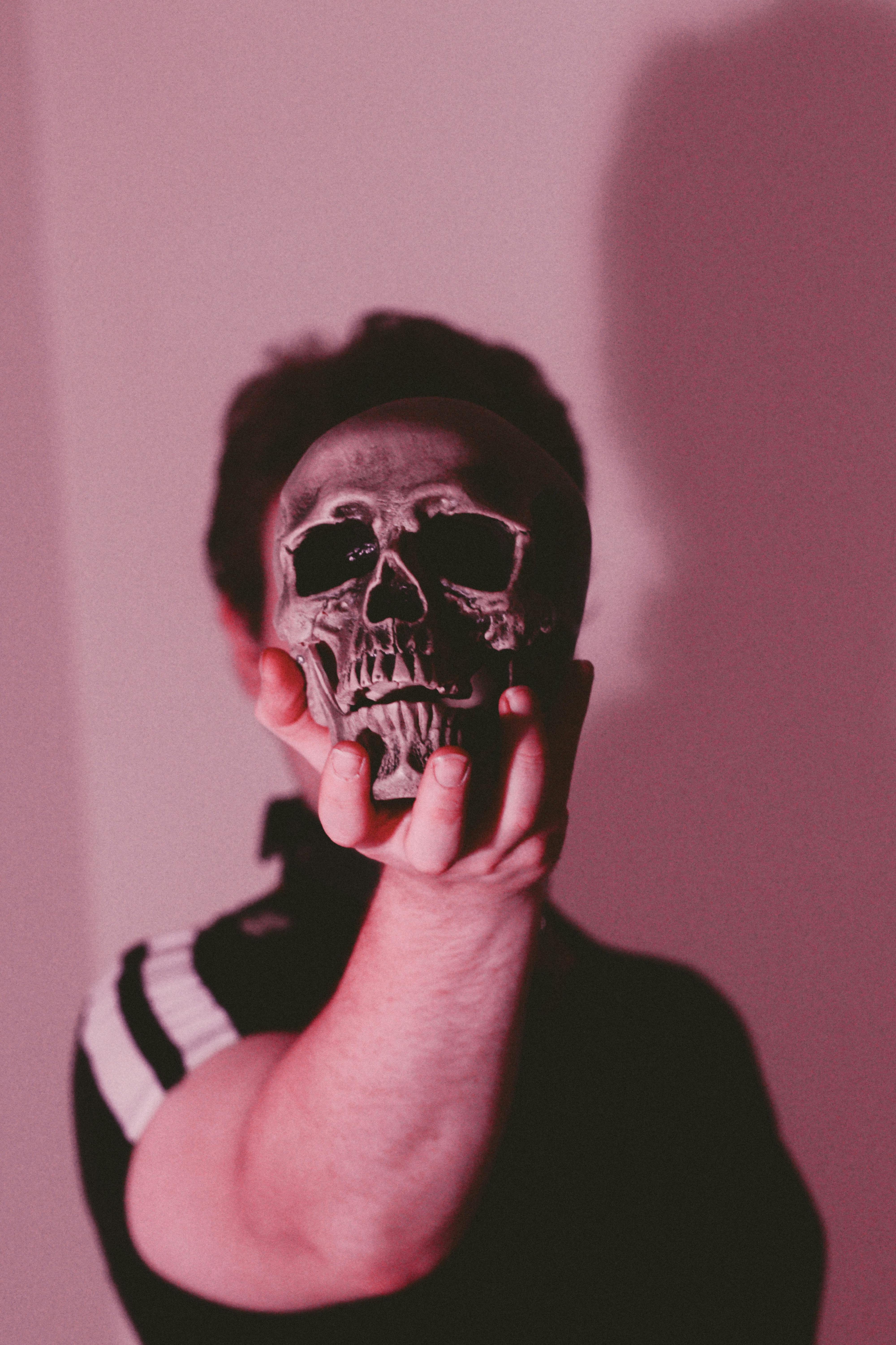 person holding a skull