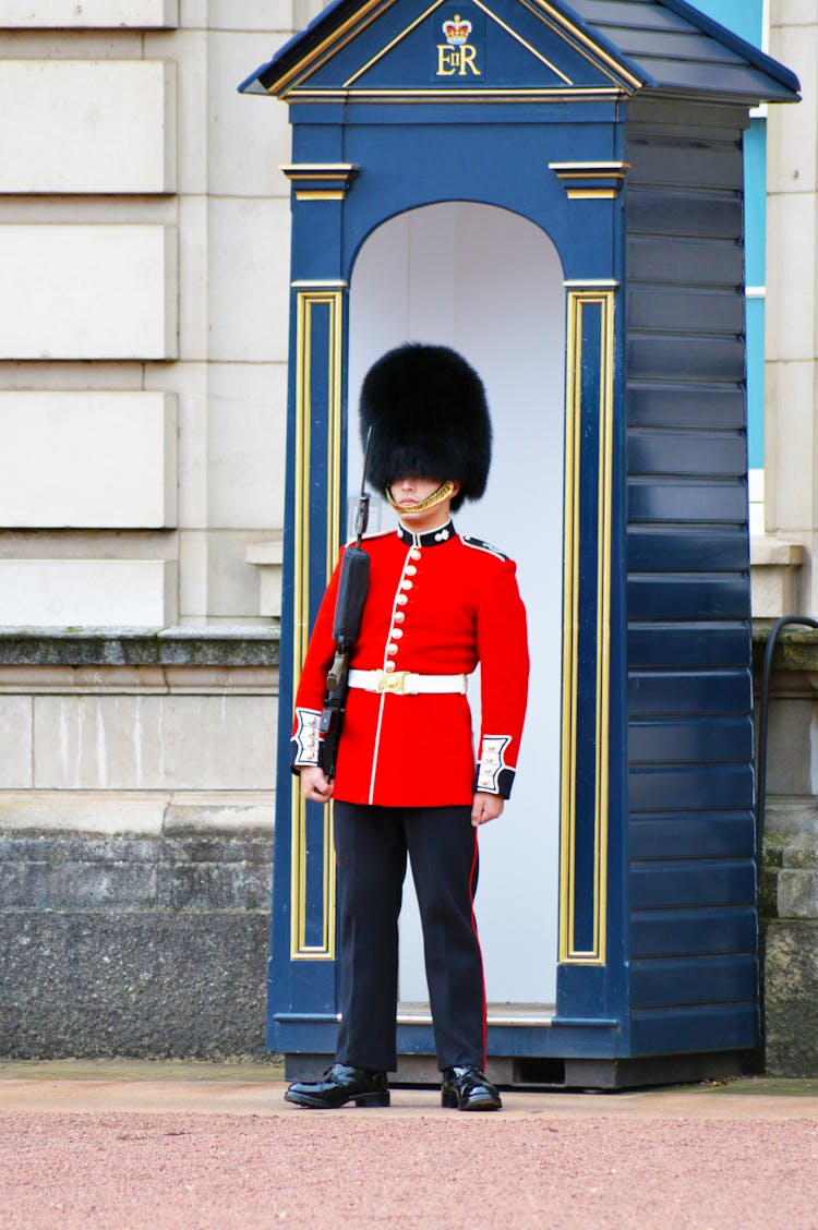 Man In Red Tudor Uniform Holding A Firearm