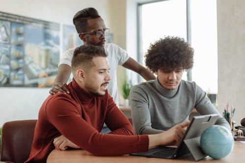 Free Men Doing Group Discussion on Laptop Stock Photo